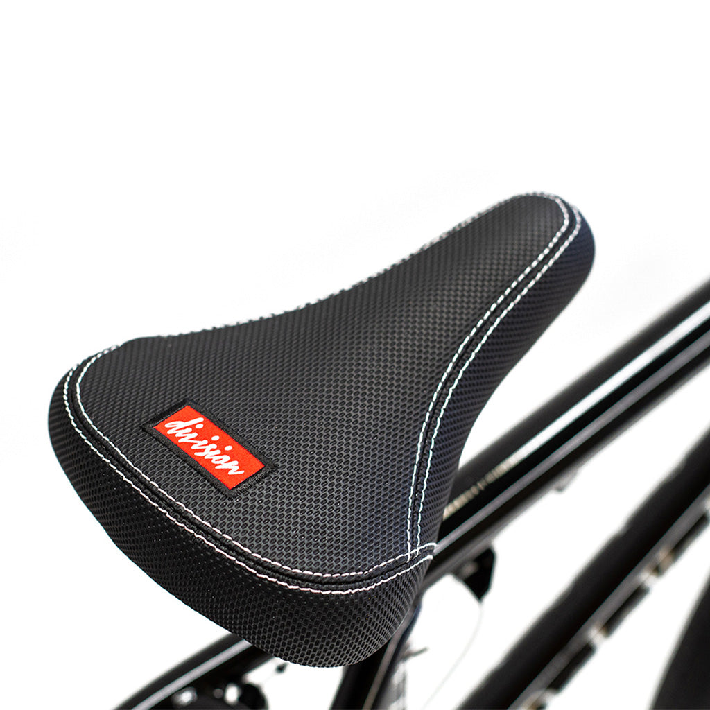A close up of a black bicycle seat featuring a Division Reark 20 Inch Bike.