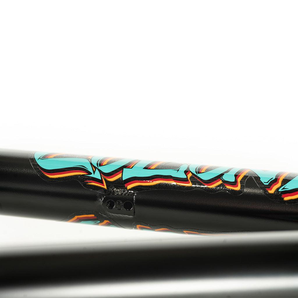 A close up of a Colony 2024 Sweet Tooth 18 Inch bike frame with graffiti on it.