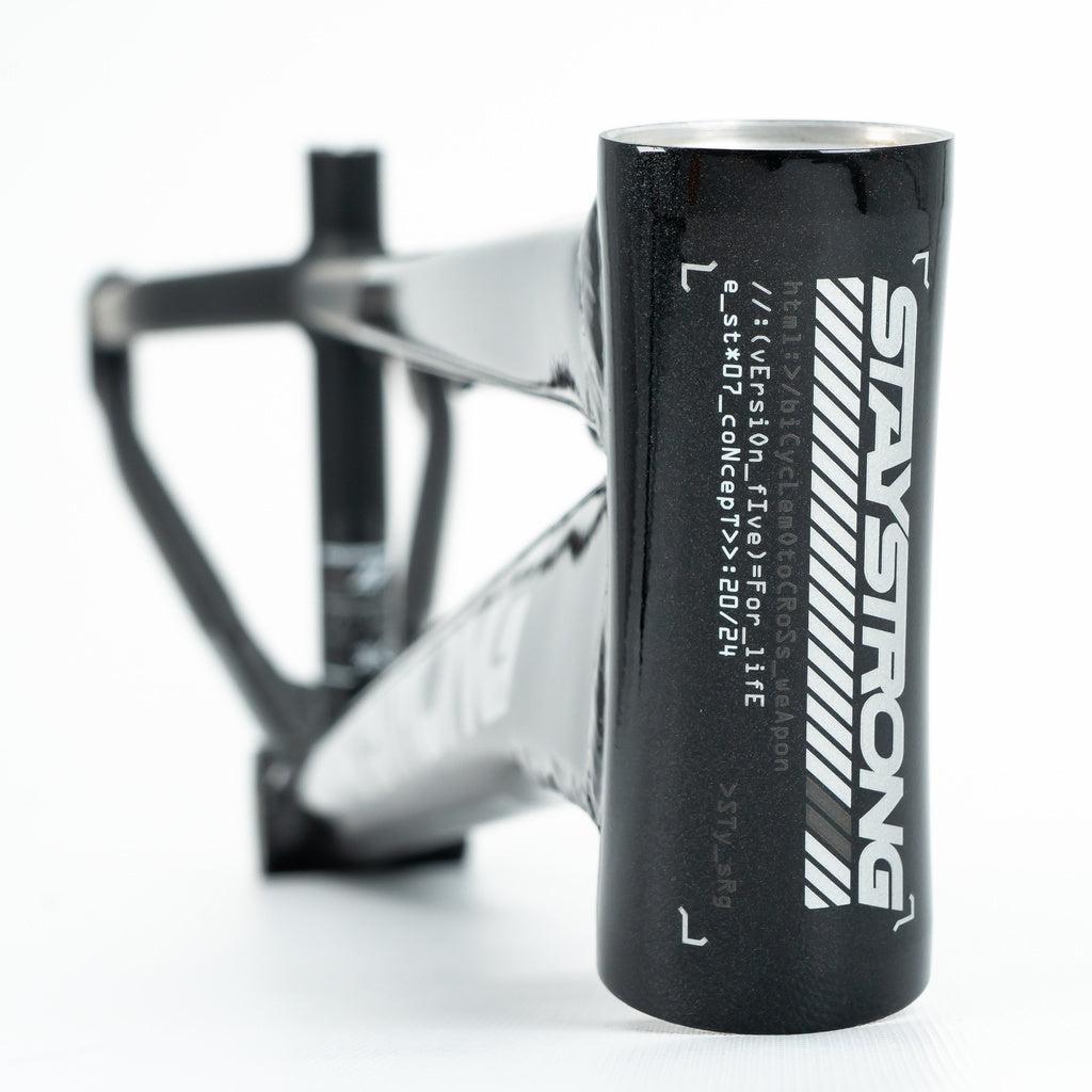 Close-up of the Staystrong V5 Disc Mini Frame, a black aluminium race frame with bold white "STAYSTRONG" lettering and white text on the head tube, highlighting quality 6061 alloy tubing from the V5 series.