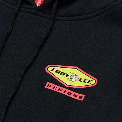 Check out the TLD 25.1 Carb Hoodie, featuring a close-up of a black design with the "Troy Lee Designs" logo in vibrant yellow and red, complete with a cozy hood to keep you snug during winter chills.