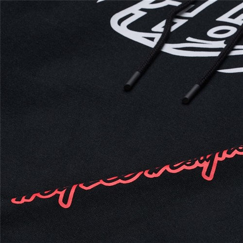Close-up of the TLD 25.1 Badge Hoodie, a black winter hoodie featuring partially visible white and red text, with black drawstrings laid across it.