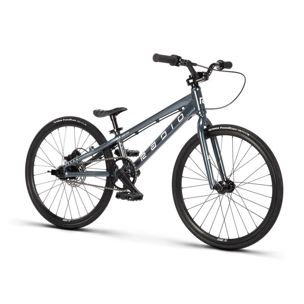 The Radio Xenon Mini Disc 20 Inch Bike is a gray BMX-style bicycle with a hydroformed 6061-T6 alloy frame, black tires, flat handlebars, and "RADIO" branding on the frame, displayed against a white background.