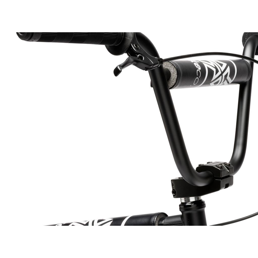 Close-up of the black handlebar with grips and padding on the Fit Bike Co Series 22 Inch Bike, showing part of its frame and handlebar stem.