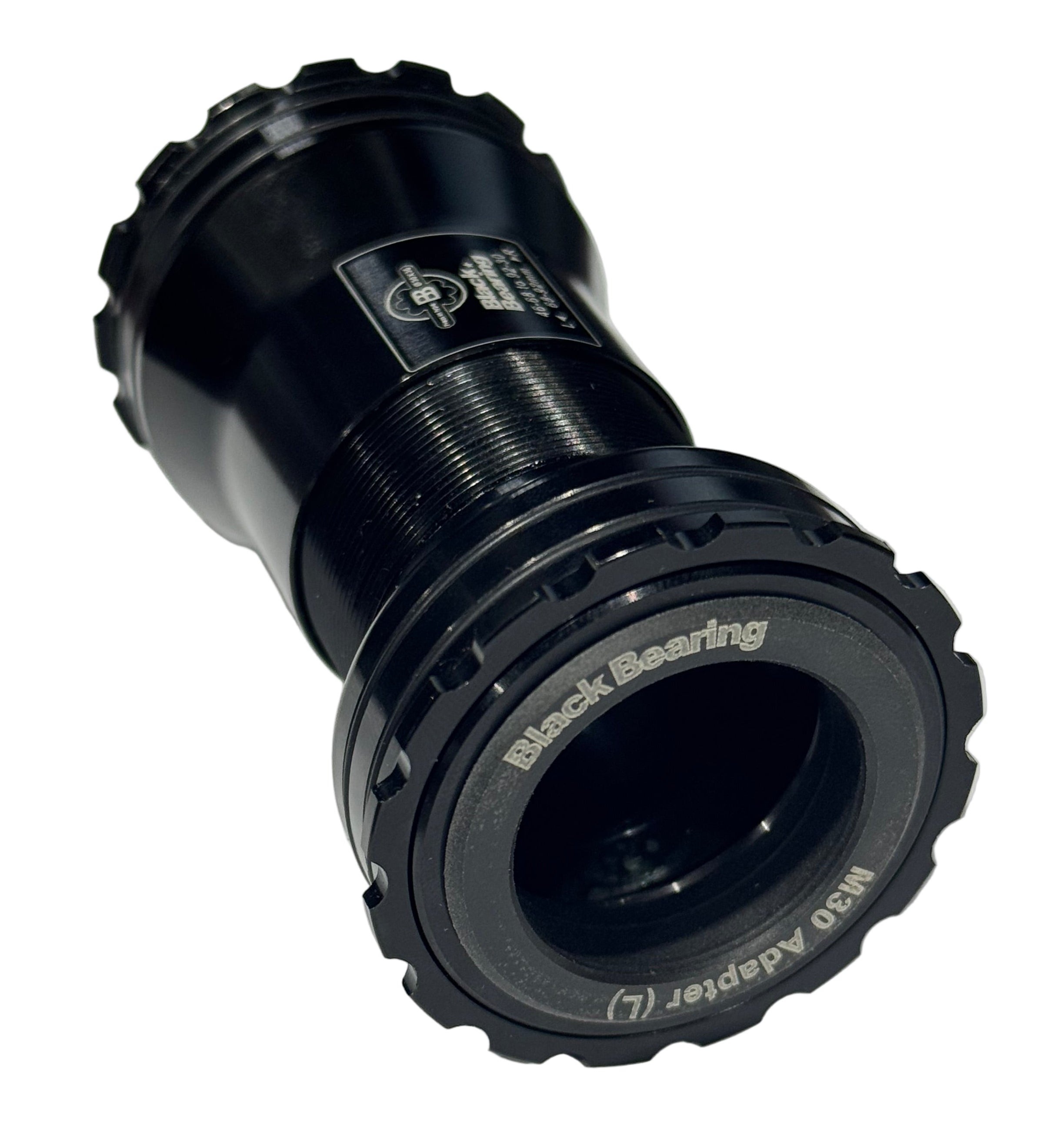 The Black Bearing B5 BB386 EVO M30 Praxis Bottom Bracket is a black CNC-machined aluminum adapter with textured edges, labeled text, and BBlock technology, shown on a white background.