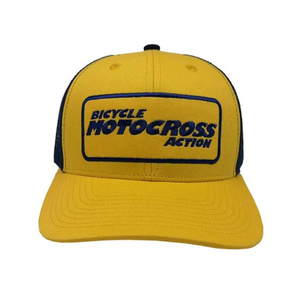 The MCS BMXA Logo Cap is a yellow and black baseball cap with a rectangular "Bicycle Motocross Action" blue patch and an adjustable snap closure for a comfortable, one-size-fits-all fit.