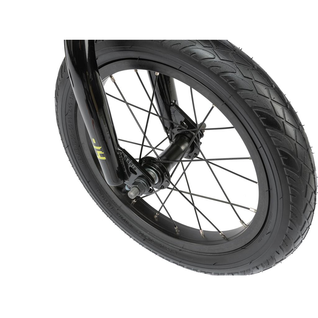 Close-up of the Radio Revo 14 Inch bike wheel, showing thick tread, sturdy metal spokes, and a black fork—ideal for a child's first ride.