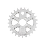 The S&M X-Man Sprocket is a silver CNC-machined 7075 T6 aluminum bicycle sprocket with a circular center hole, cut-out triangles, 1/8″ teeth, and "S&M BIKES" engraved at the bottom. Made in the USA.