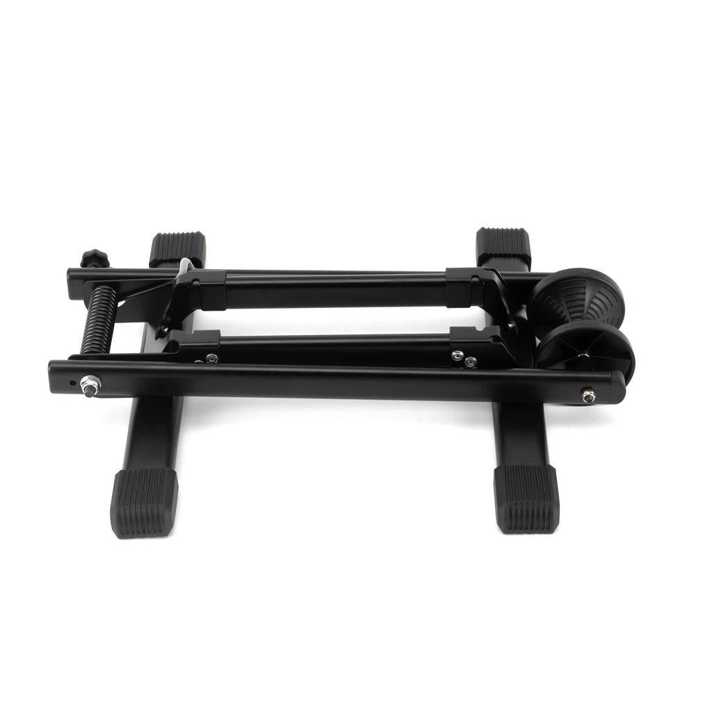 The 6MIL BS-01 Bike Stand is a black heavy-duty model with rubberized feet and wheels, shown from above on a white background.