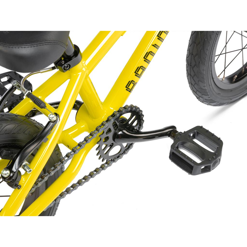 Close-up of the pedal, chain, and frame section of the Radio Revo 14 Inch bike, highlighting drivetrain and rear wheel details—ideal as a first bike—set against a white background.