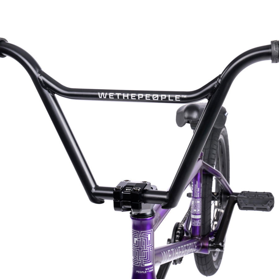 A purple Wethepeople Trust 20 Inch Freecoaster Bike with a black handlebar.