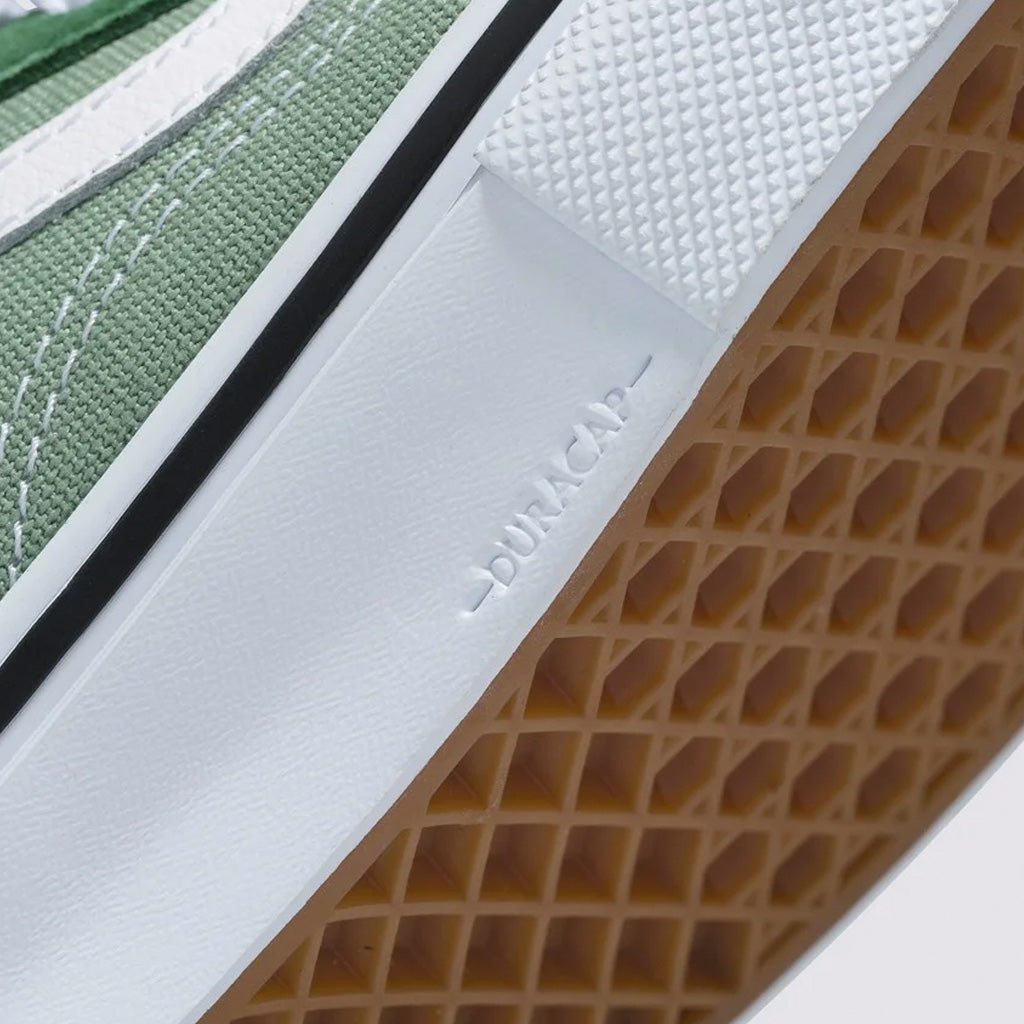 A close up of a green Vans Skate Old Skool shoe with white soles, designed for pro-level skateboarding.