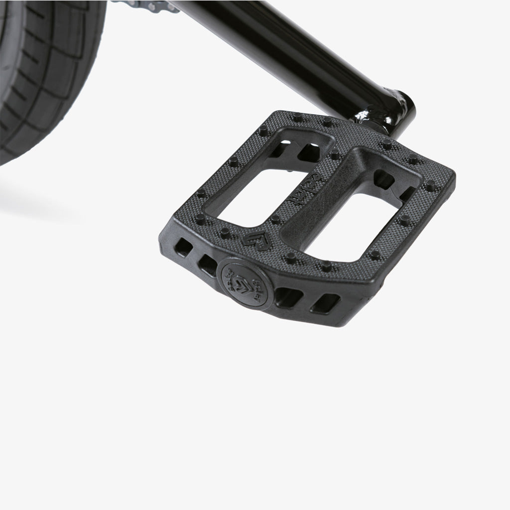The description showcases the Wethepeople CRS 20 Inch Bike, a close up of a black pedal on a bicycle.