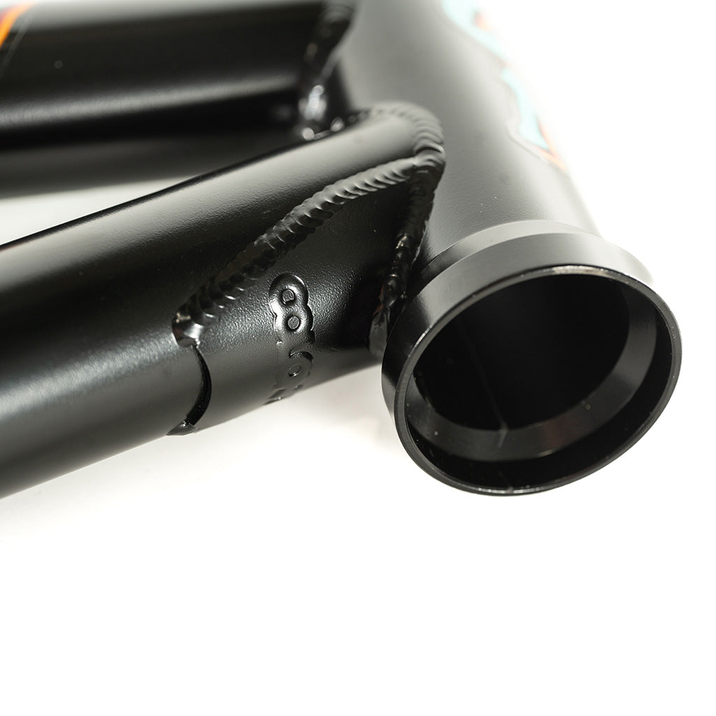 A close up of a black Colony 2024 Sweet Tooth 18 Inch BMX bike frame with an orange tube.