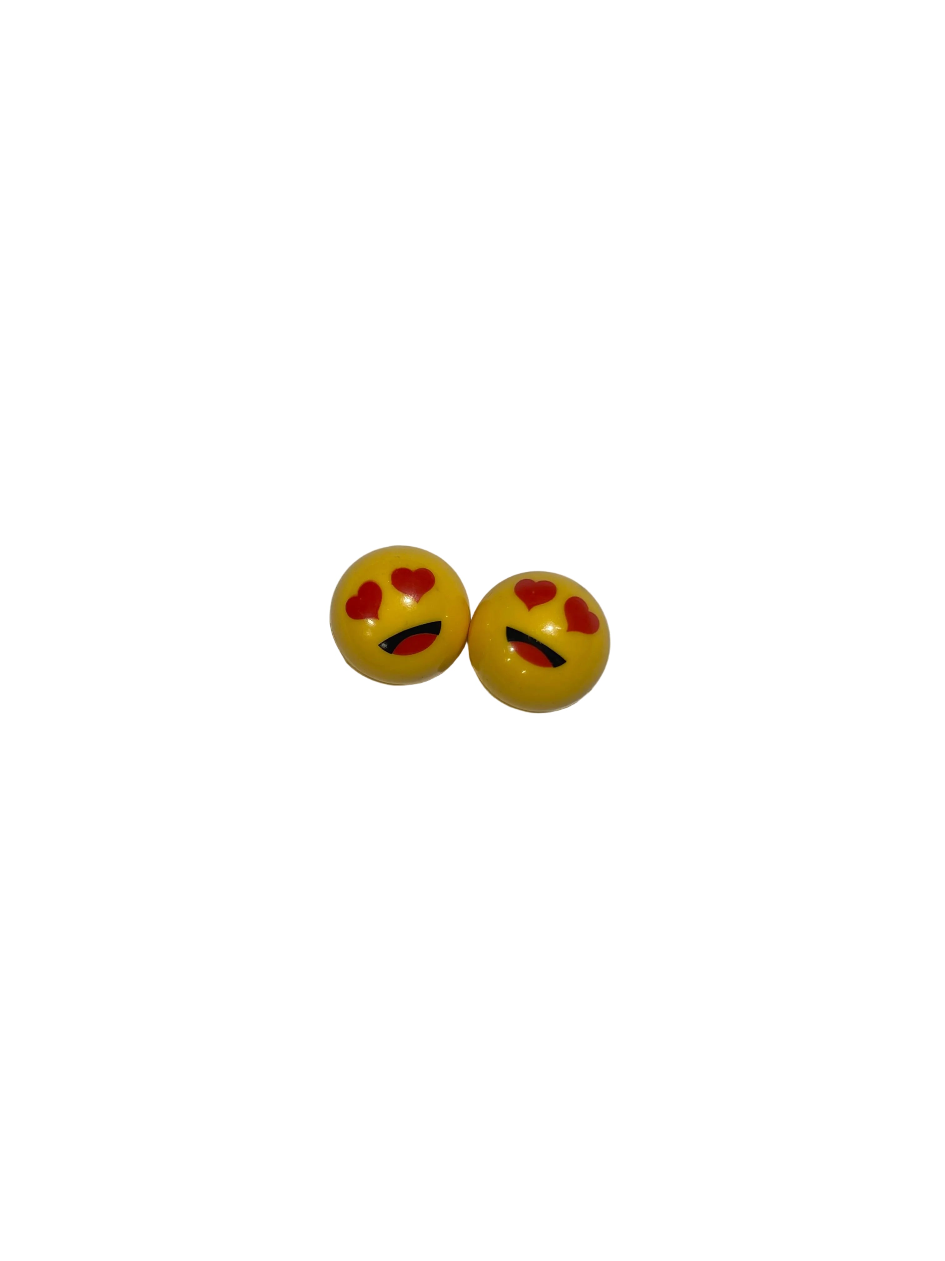 Lovey Dovey Schrader Valve Caps (Pair): Round yellow caps with heart-shaped eyes and a curved black mouth, perfect for adding fun flair to your BMX or showing your love for cycling.