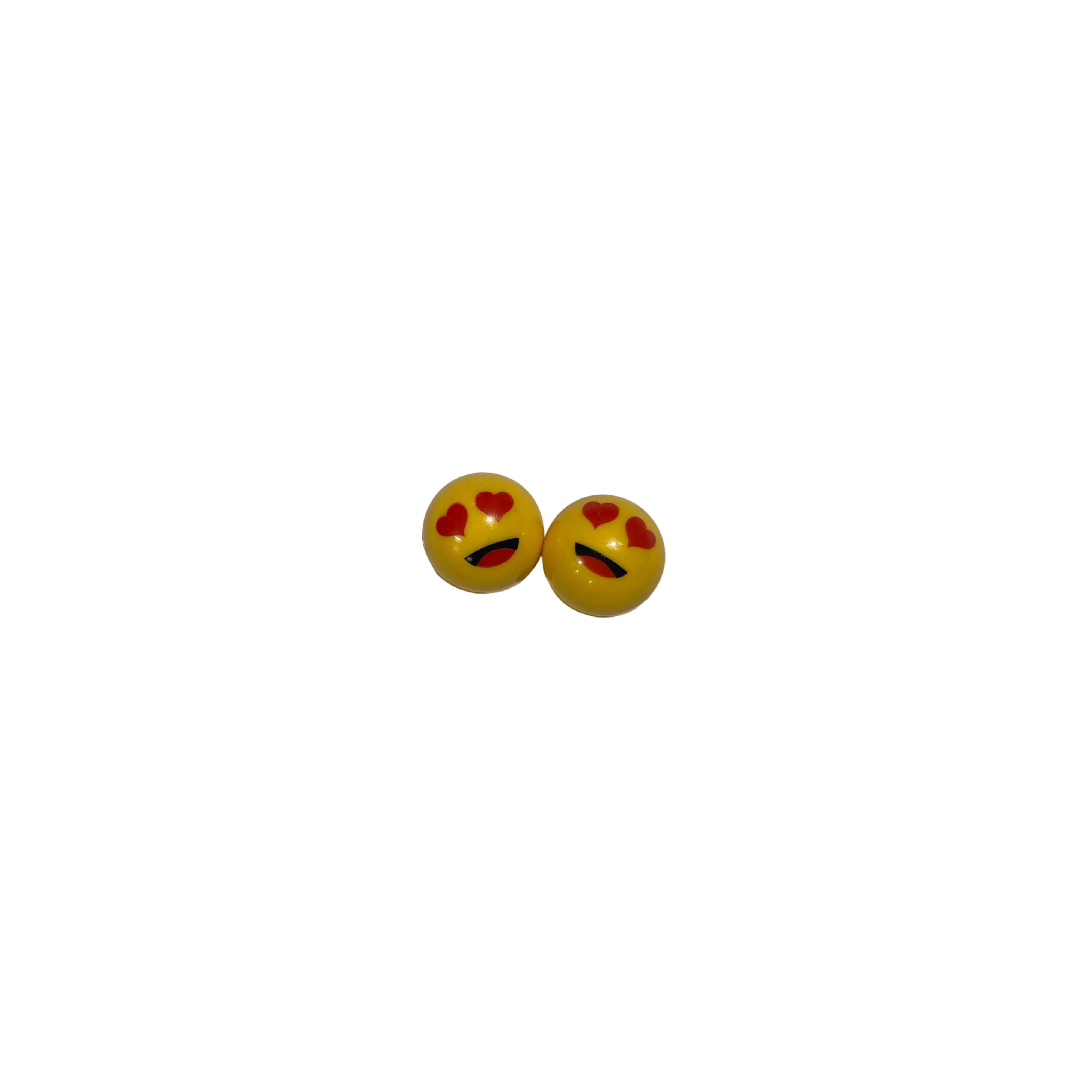 Lovey Dovey Schrader Valve Caps (Pair): Round yellow caps with heart-shaped eyes and a curved black mouth, perfect for adding fun flair to your BMX or showing your love for cycling.