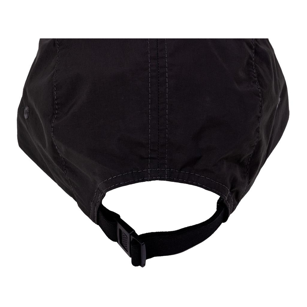 Close-up of the back of a black Odyssey Campus Cap, showing its adjustable strap with a plastic buckle.