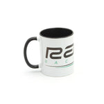 The Radio Raceline Coffee Mug is a white ceramic mug with a black handle and rim, featuring partial text and a green underline design on a plain white background.