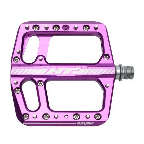 The HT Components ANS12 Raven Pedals are purple aluminum mountain bike pedals with multiple grip pins and two large cutouts, shown from the side with the spindle visible on the right.