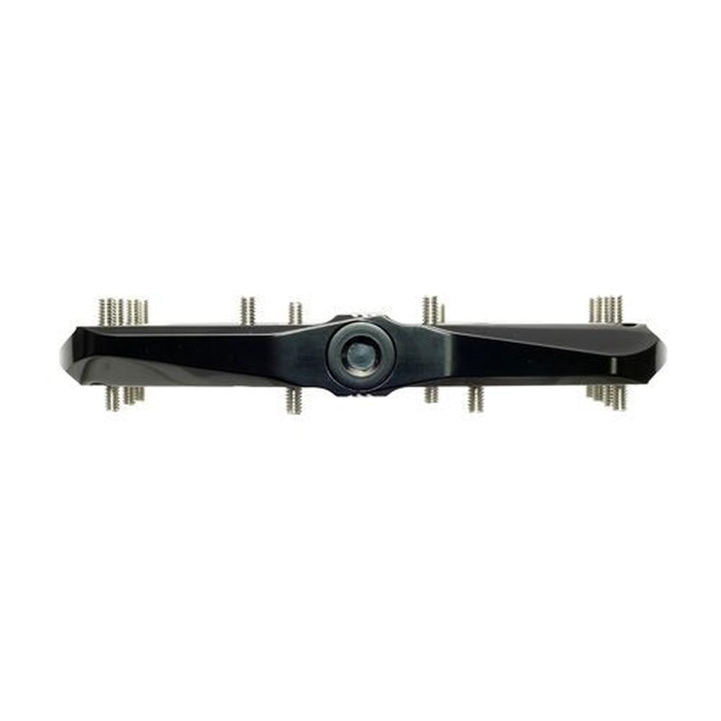 A black, bar-shaped HT Components ANS12 Raven Pedal with a central circular lens and multiple grip pins or screws on both sides, shown from the front against a white background.