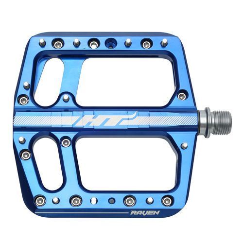 The HT Components ANS12 Raven Pedals are blue aluminum platform pedals with a large cutout design, multiple replaceable grip pins, and the "Raven" branding—ideal flat bike pedals for cyclists seeking reliability.