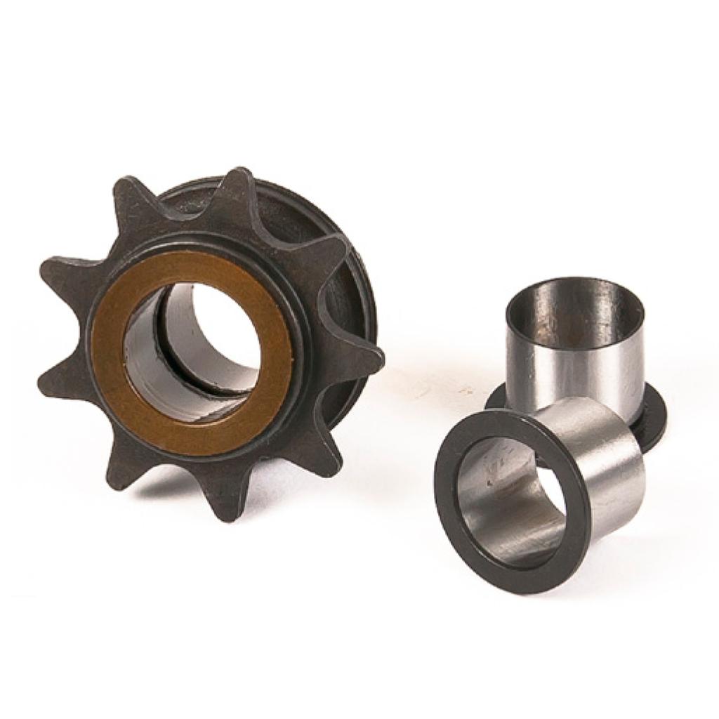 An Eclat Dynamic Hub Driver with a metal sprocket and bronze inner ring is shown next to two cylindrical steel bushings on a white background, ideal as an 8T driver replacement.