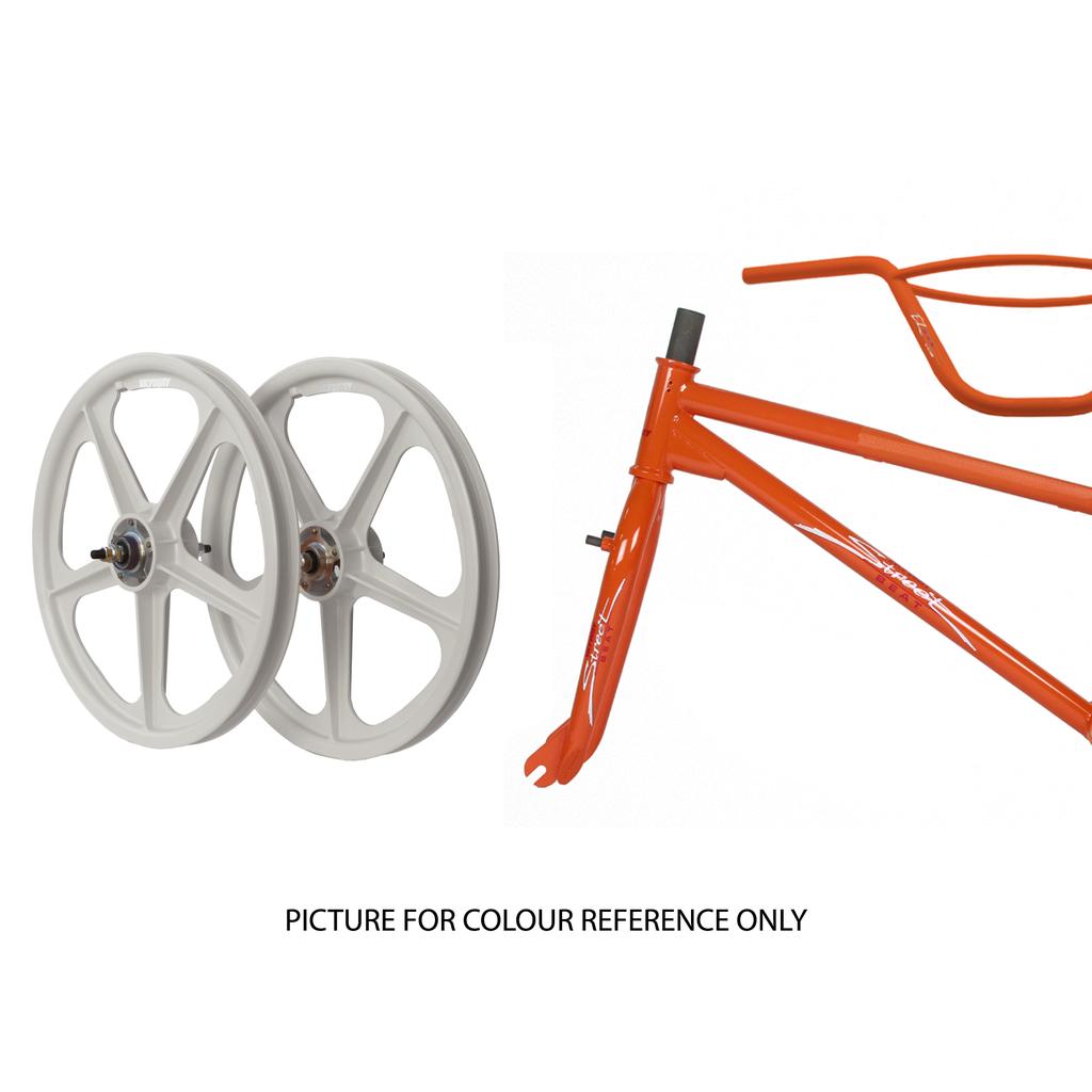Two white mag wheels are displayed next to an orange Skyway Street Beat EX 20 Inch Bike frame. Text below states, "PICTURE FOR COLOUR REFERENCE ONLY.