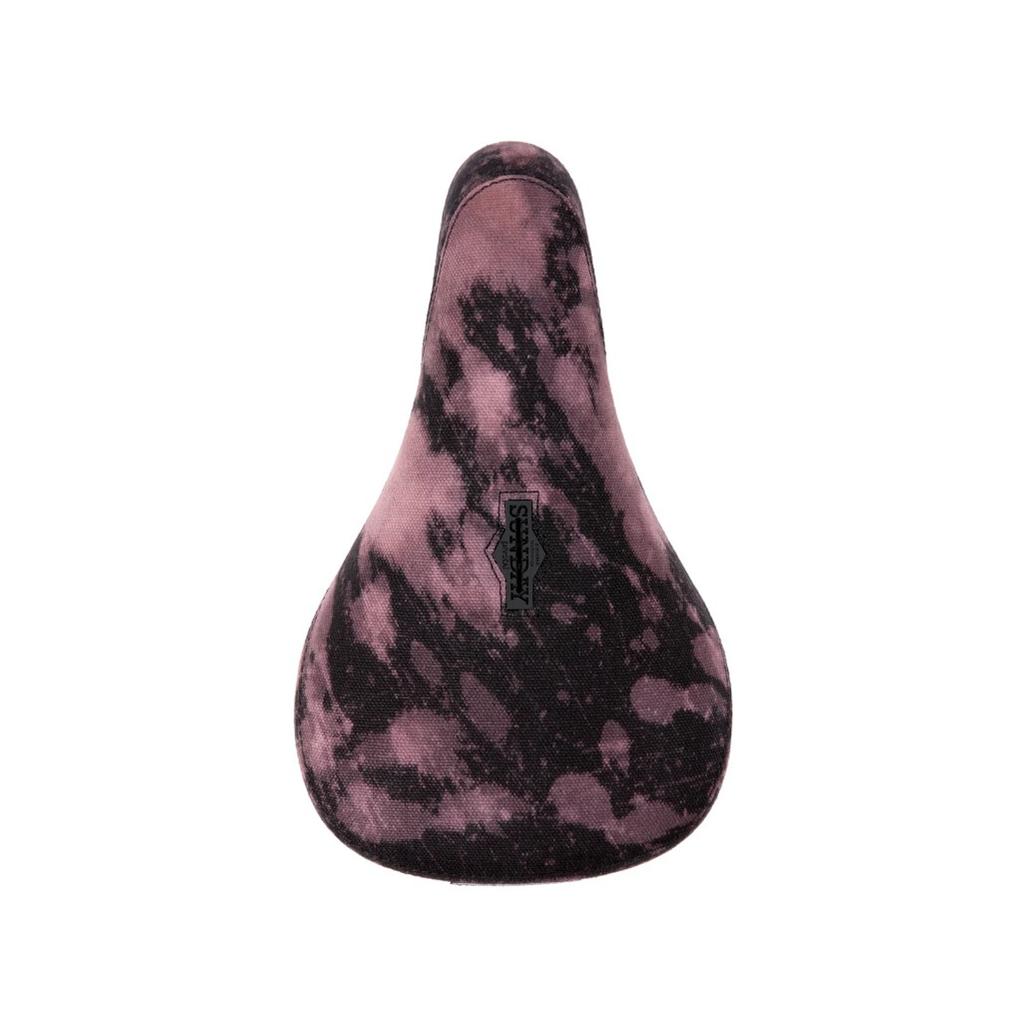 The Sunday Bleached Pivotal Seat (Brett Silva Signature) features a purple and black marbled design with a small rectangular center logo tag, styled in the Pivotal format.