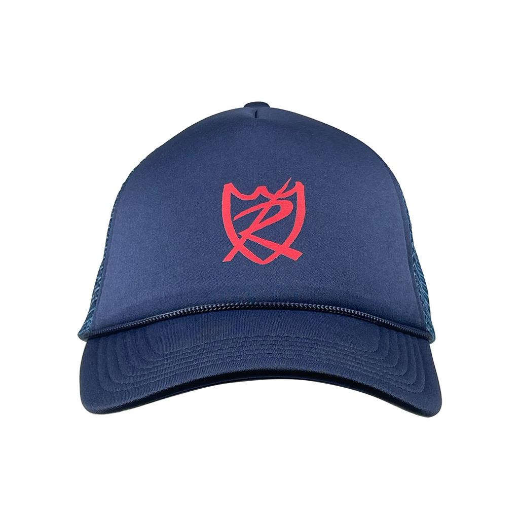 The S&M Rambler Sharpie Shield Cap is a navy mesh back hat with a red abstract shield and letter design on the front and an adjustable snapback closure.