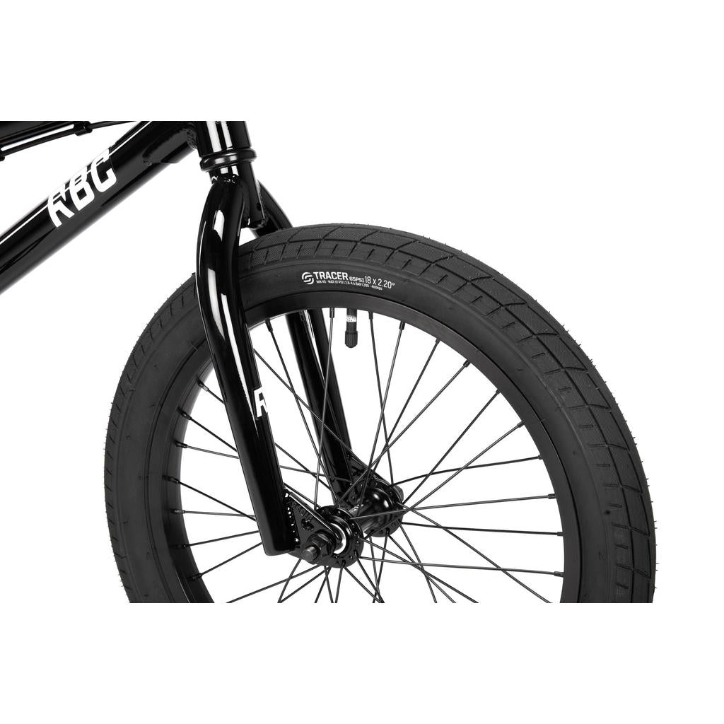 Close-up of the front wheel and fork of a black Radio Dice 18 Inch Bike, showing Salt Tracer Tyres, spokes, and part of the frame with "KGB" branding.