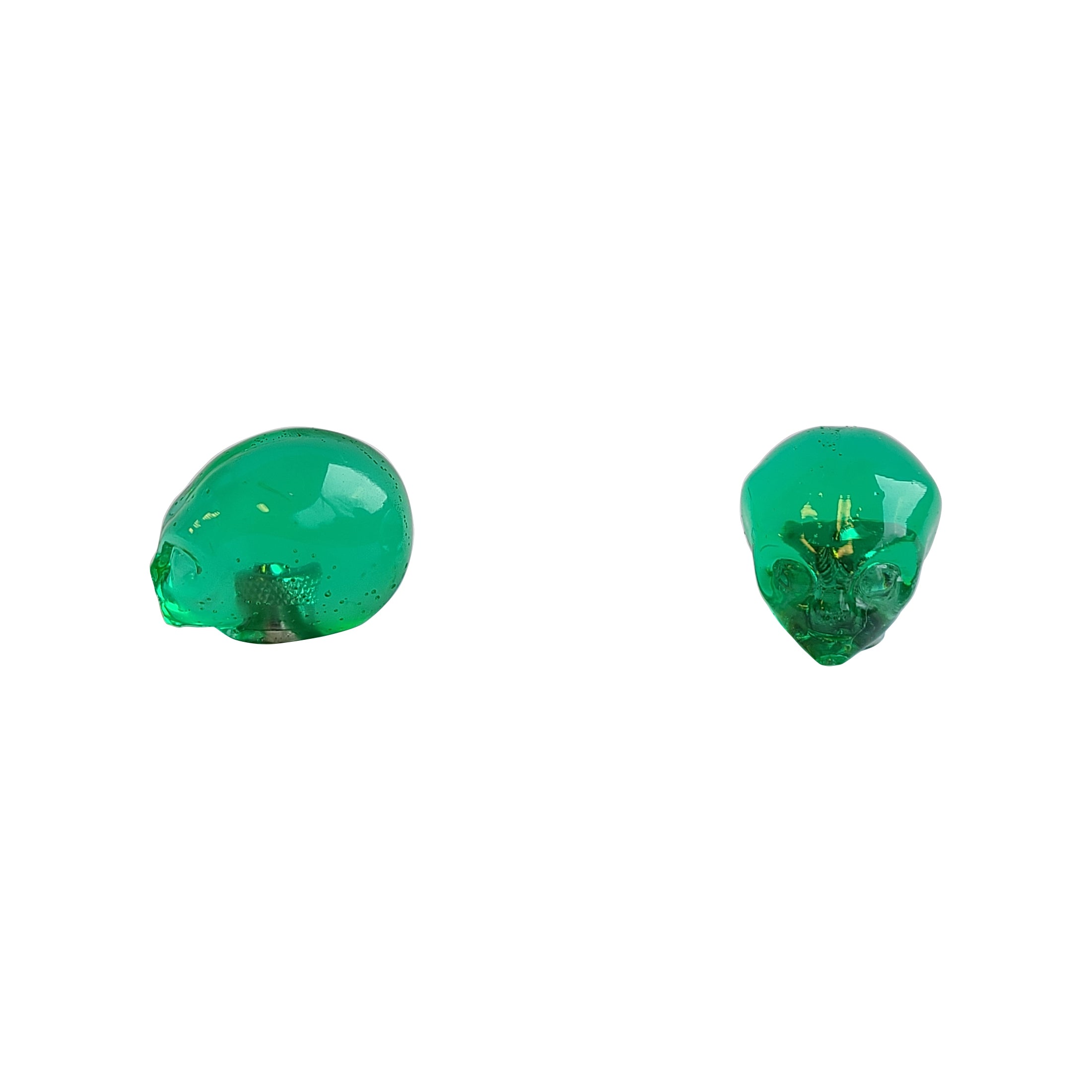 Two small green Alienation Alien Valve Caps, crafted from translucent resin and shaped like alien skulls, are displayed on a white background—one in side view and one in front view for distinct Area 51 vibes.