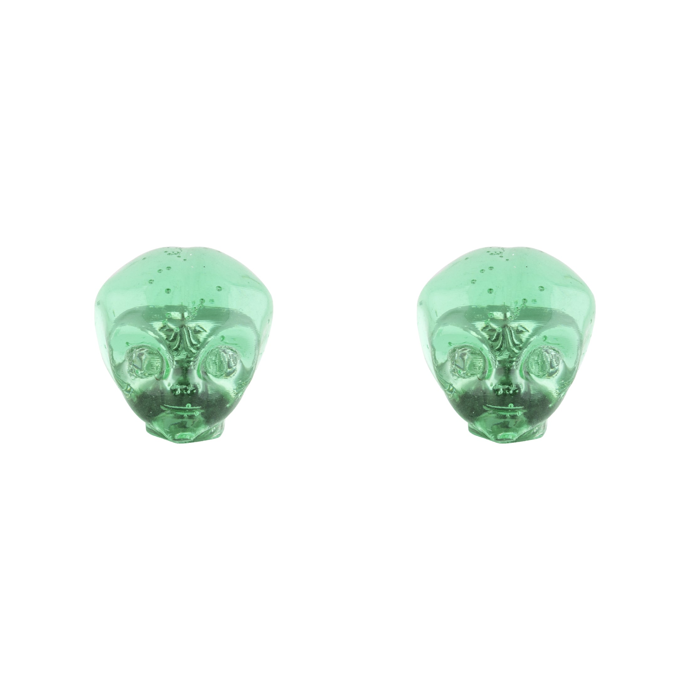 Two translucent green resin objects shaped like alien heads sit side by side on a white background, resembling Alienation Alien Valve Caps designed for Schrader valves.