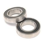 Two Eclat Teck Hub Bearing Set (6903) bearings with black seals are displayed on a white background, one lying flat and the other positioned at an angle on top.
