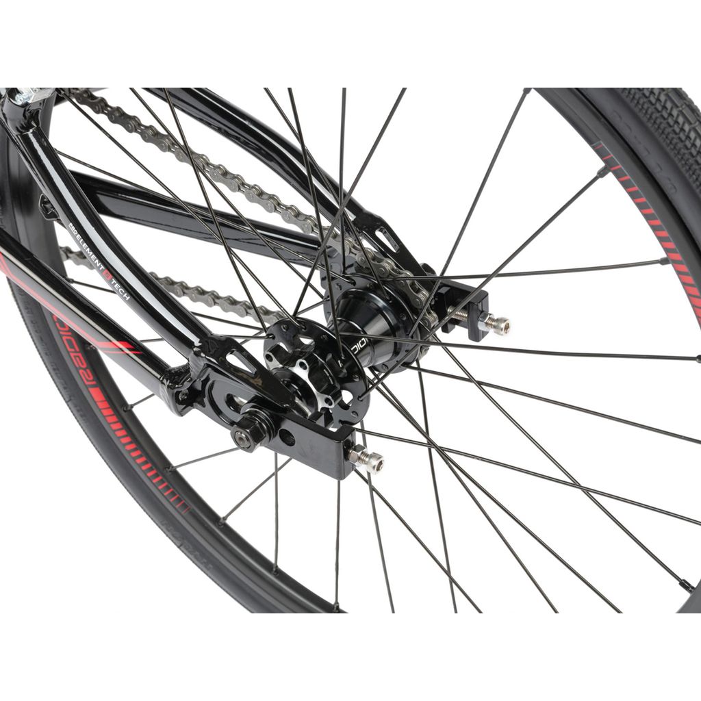 A close up of a black Radio Xenon Junior Bike with red spokes.