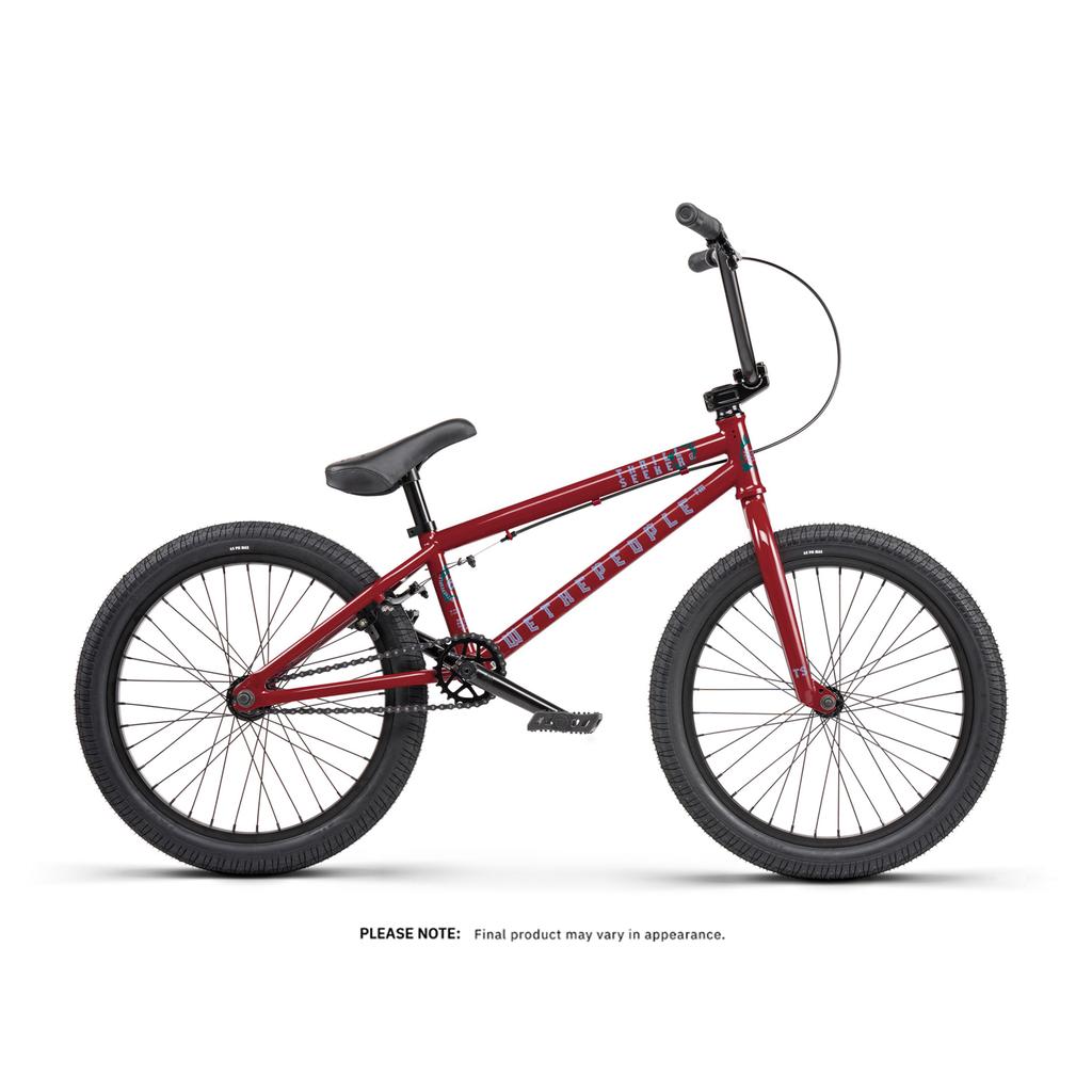 A Wethepeople Thrillseeker 20 Inch Bike in red, featuring black handlebars, seat, and tires, is displayed in a side profile against a white background.