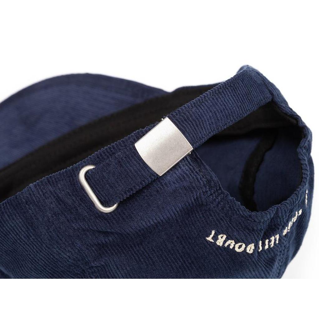Close-up of the adjustable strap and metal buckle on the BSD More Speed Cap, highlighting quality details on this classic navy blue corduroy 6-panel hat.