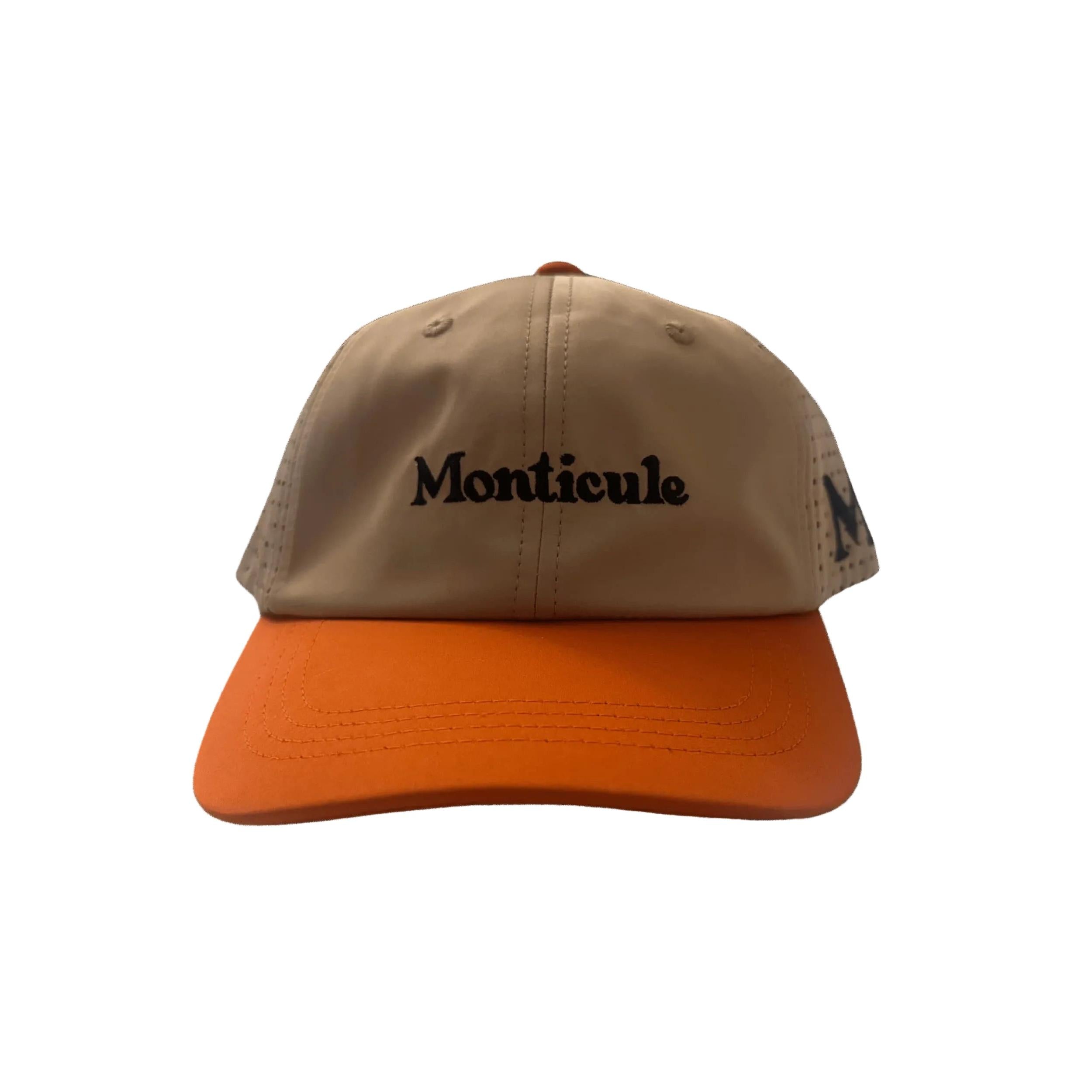 The Monticule Vapor Strap Back Hat features a tan and orange design with "Monticule" embroidered in black on the front. This breathable hat is stylish and comfortable, perfect for everyday wear.