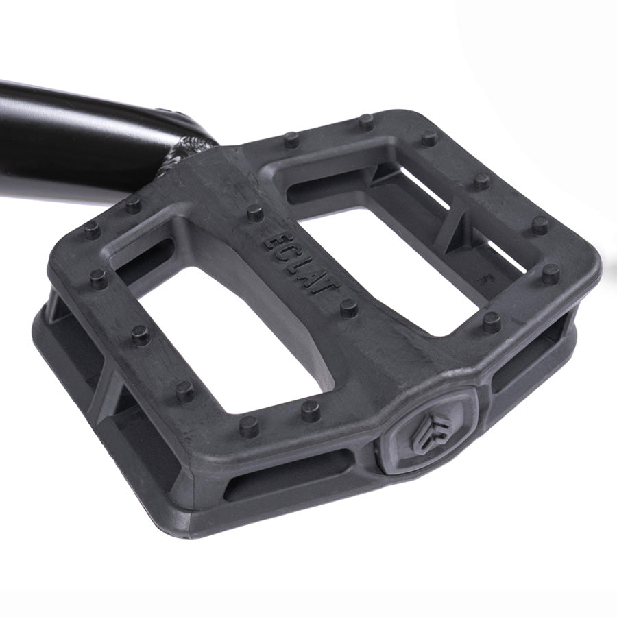 A pair of black pedals with a black handle that perfectly complements the sleek design of the Wethepeople Trust 20 Inch Cassette Bike.