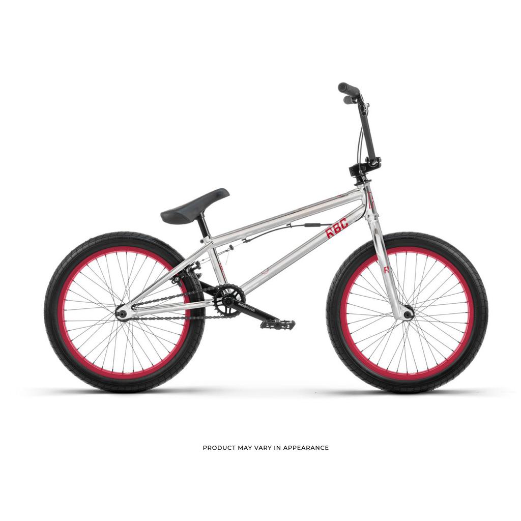 The Radio Astron FS 20 Inch Bike features a silver chromoly frame, black handlebars, seat, and tires, plus red wheel rims. Shown in side profile on a white background, this BMX bike truly stands out.
