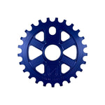 The S&M X-Man Sprocket is a blue CNC-machined bicycle sprocket made from 7075 T6 Aluminum, featuring five radial cutouts and evenly spaced teeth, displayed against a white background.