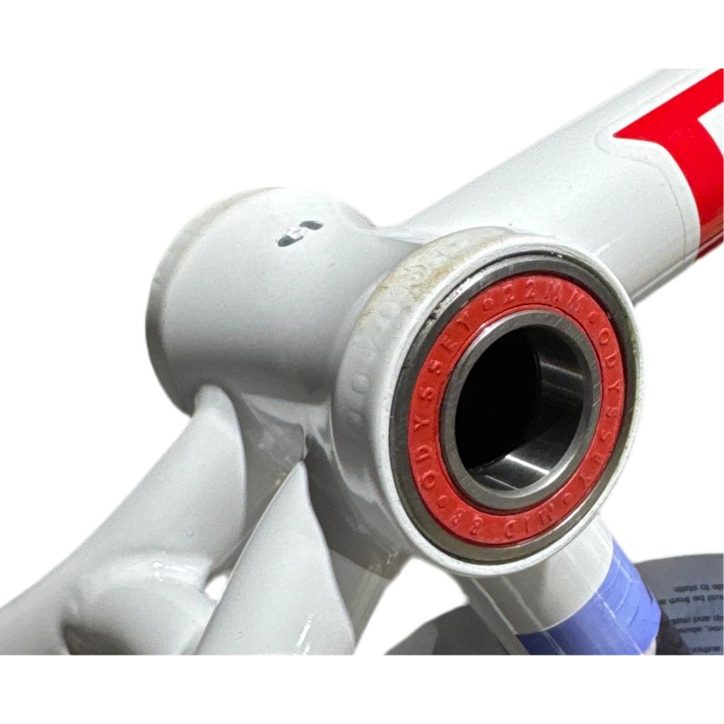 Close-up of a Fiend Mills Frame bike, highlighting its red and silver Odyssey bottom bracket bearing and strong chromoly tubing.