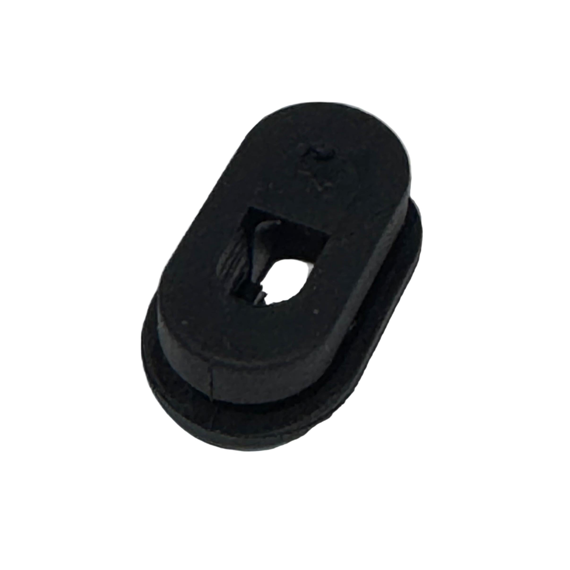 The Grommet For Internal Brake Hose Routing is a black, oval rubber grommet with a central rectangular hole and surrounding ridge, designed for internal brake hose routing, shown on a white background.