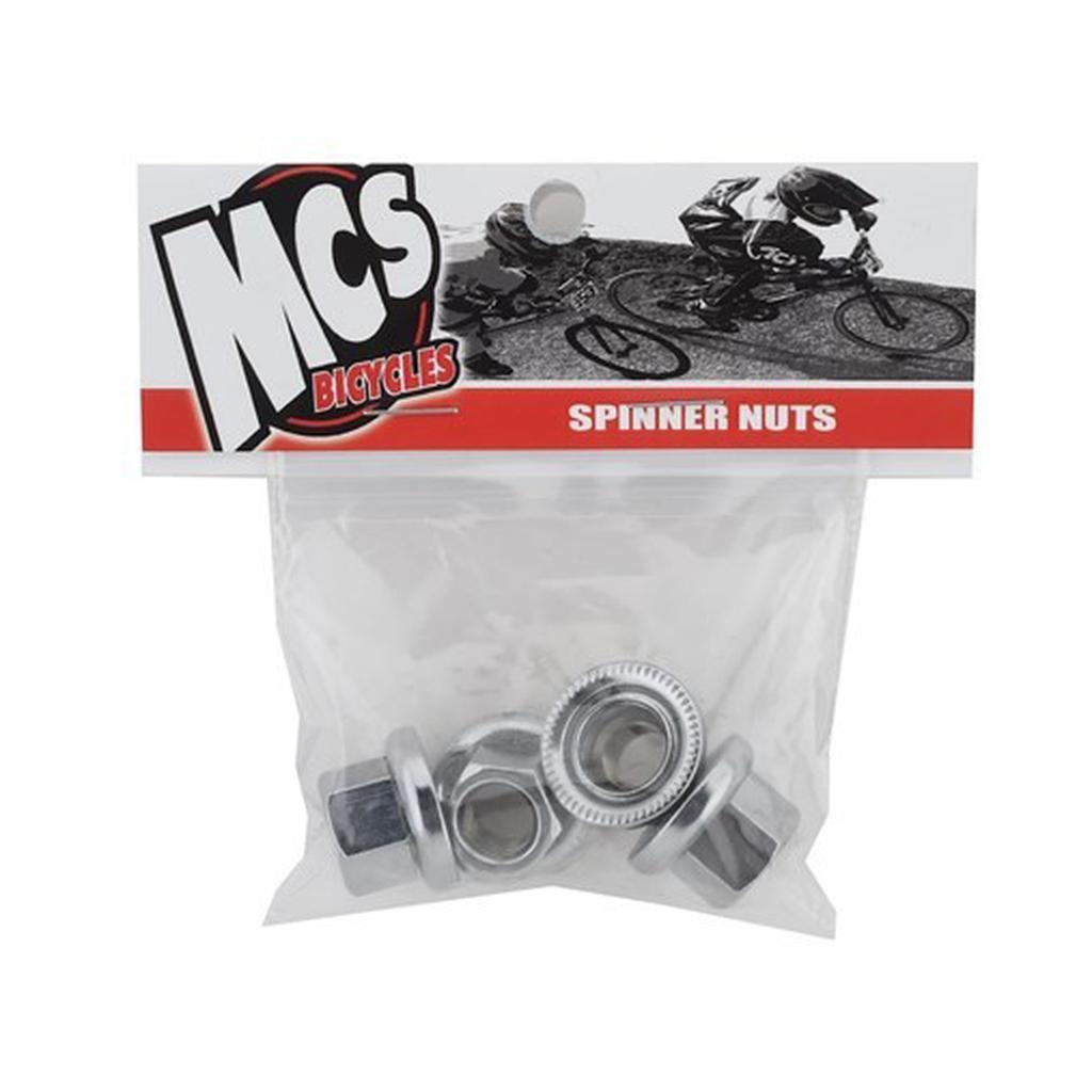 A clear bag labeled "MCS Spinner Axle Nuts (4 Pack)" contains four metal BMX axle nuts and features a photo of BMX cyclists—ideal for anyone looking for quality retro BMX parts.
