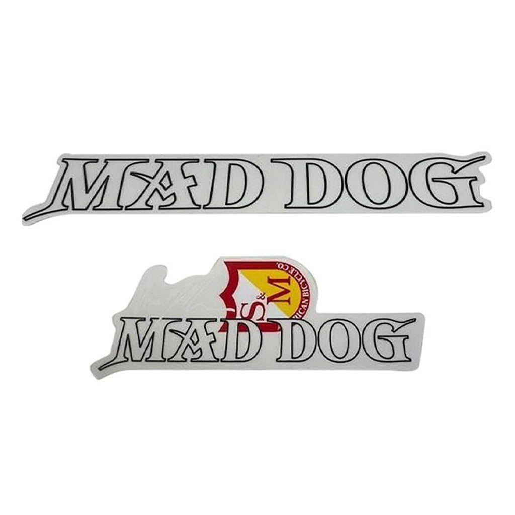 The S&M Mad Dog Frame Decal Set includes two stickers with "MAD DOG" in black outlined font; the bottom sticker has a red and yellow shield design for an eye-catching look.