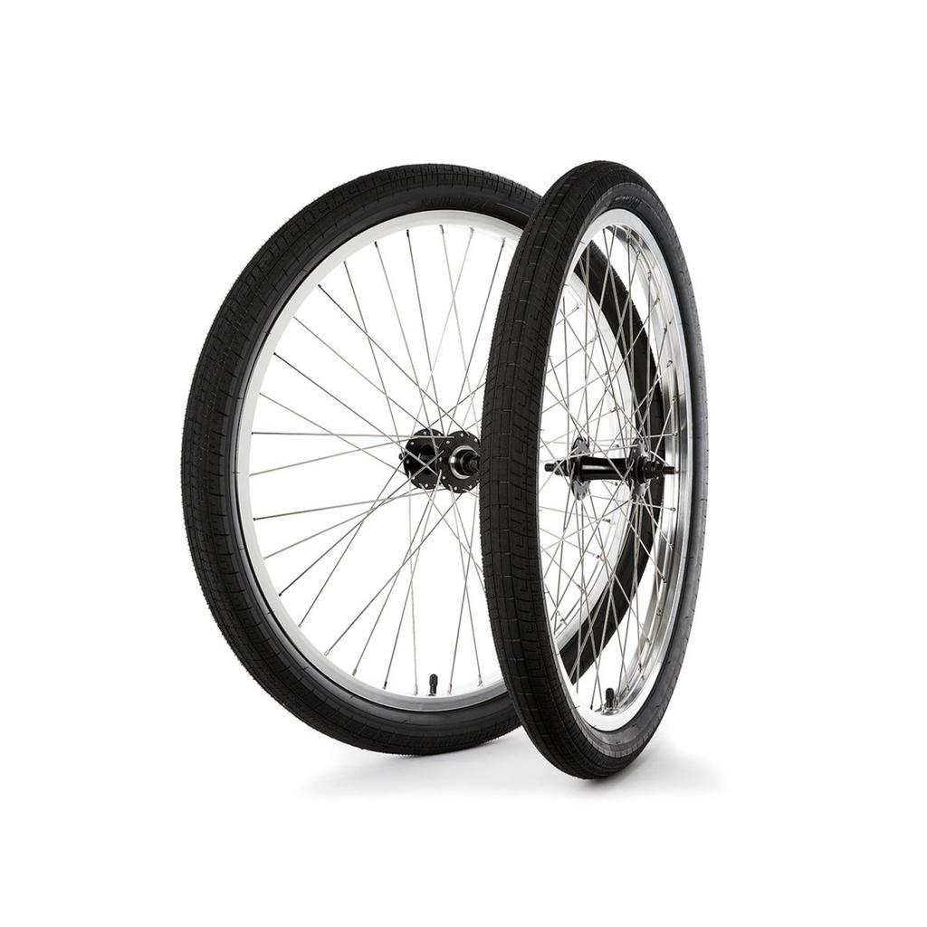 The S&M Covid 26 Inch Wheel Set features two black bicycle wheels with silver spokes and double wall rims, shown upright side by side against a white background.