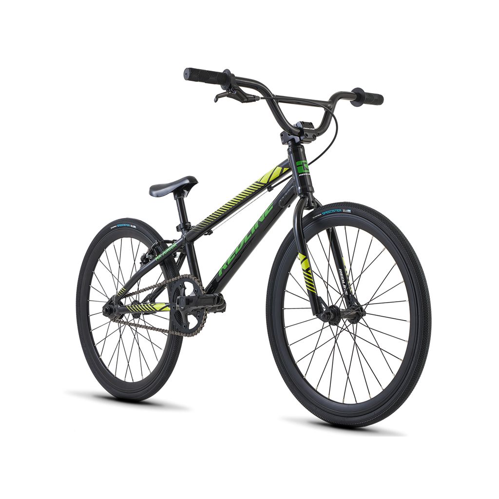A black BMX bike with neon green accents, equipped with thick tires, wide handlebars, and a comfortable seat. The Redline MX Junior Bike features an aluminum frame designed for freestyle riding and BMX racing.