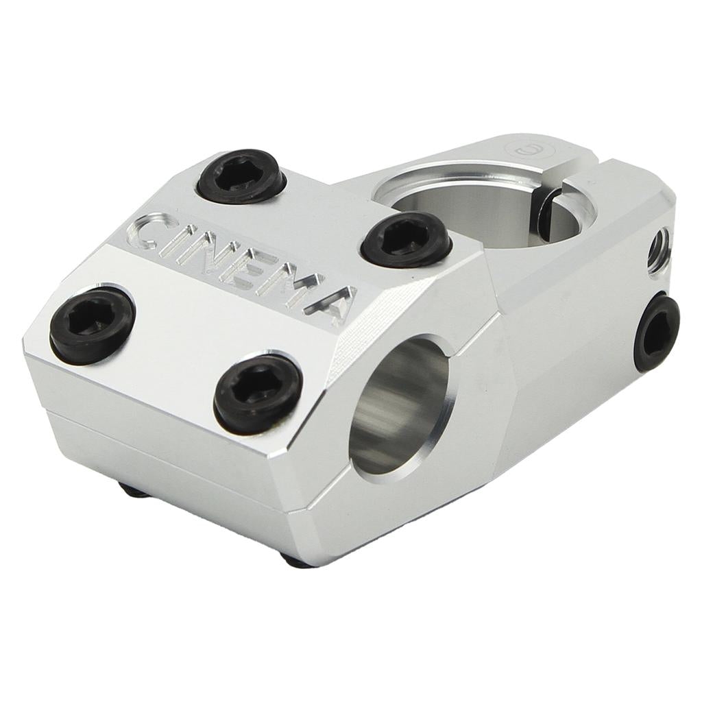 The Cinema Analog Low Top Load Stem features a silver finish, six black bolts, "CINEMA" engraving on the front, and a handlebar clamp—expertly crafted from durable 6061-T6 aluminum in Cinema’s classic design.