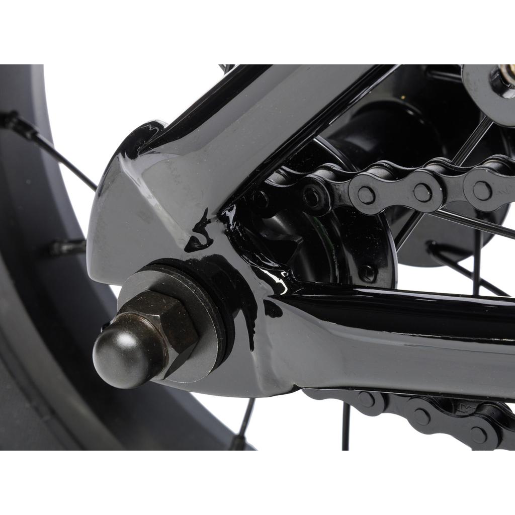 Close-up of the Fit Misfit 12 Inch Bike’s rear wheel, showcasing the axle, chain, and sturdy black frame—ideal as a first pedal bike. White background.