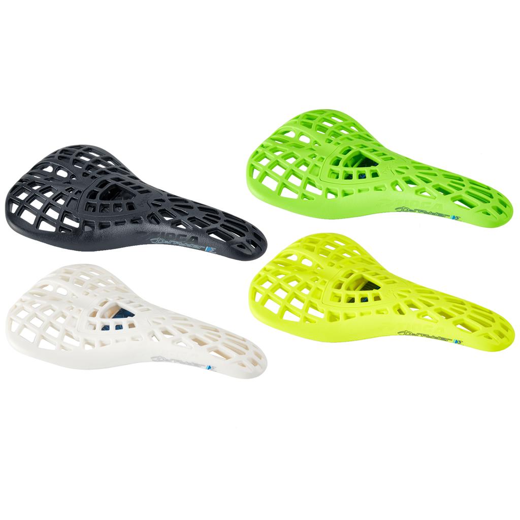 Four Tioga Spyder Pivotal Seat S Spec BMX seats with a lattice pattern, in black, green, white, and yellow, are arranged on a white background.