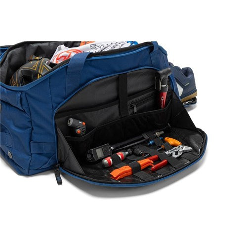 A blue Albek Skytrail 51 Gear Bag with its front compartment open, revealing organized gear storage and neatly arranged accessories in pockets—ideal for any adventure.