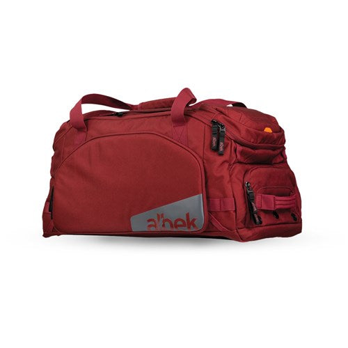 The Albek Skytrail 51 Gear Bag is a large red duffel with multiple zippered compartments, two carrying handles, and a shoulder strap. "a'nek" appears on a gray patch on the front pocket—ideal for storing your gear.